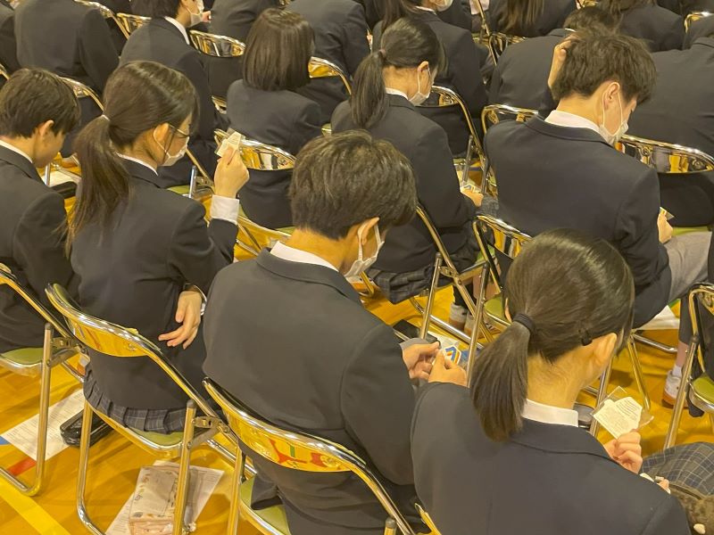 生徒さんが手元のALLYステッカーを見ている様子